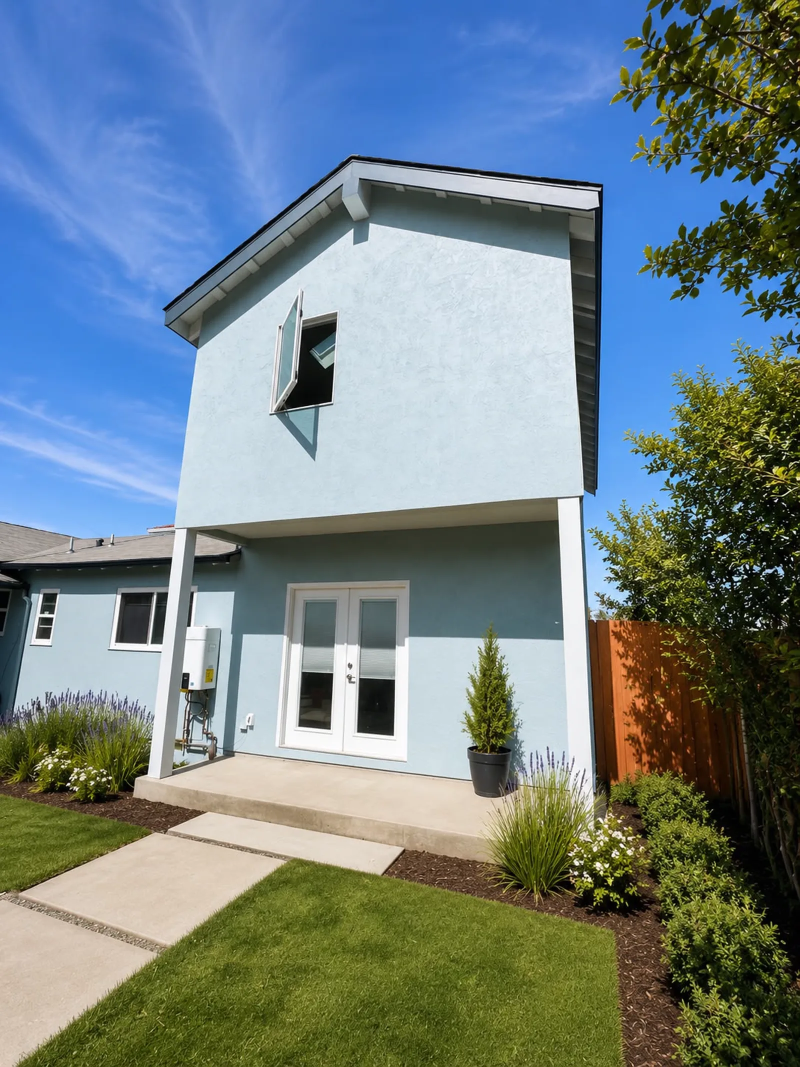 Covered entry of the attached ADU with French doors and landscaping