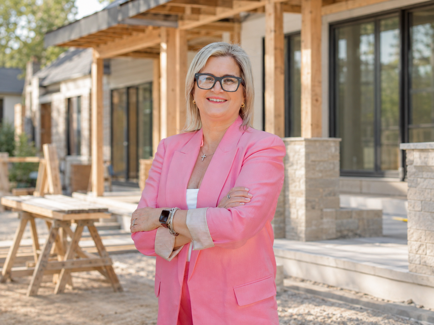 Andrea Costanzo, residential designer, on a Peninsula job site holding rolled drawings